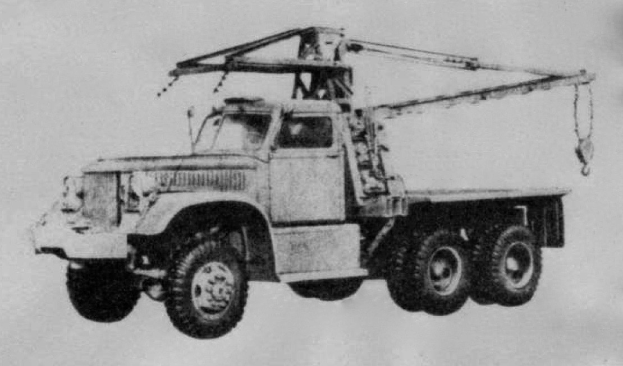 Ein Schwarz-Weiß-Foto eines großen, vierrädrigen Trucks mit einem Kran auf dem Anhänger, der als erstes Schwerlastfahrzeug gilt.