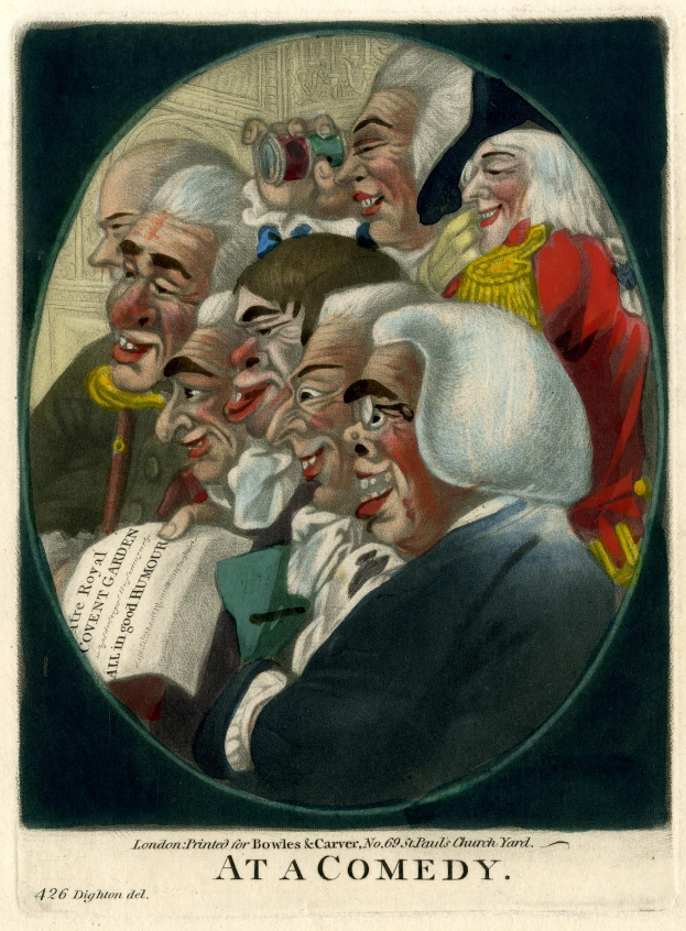 Eine Gruppe von Menschen in einem Kreis, die lachen, wobei eine Person ein Blatt Papier hält, auf einer Comedy-Veranstaltung.