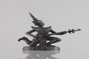 Bronzestatue eines Mannes, der eine Gitarre spielt, vor weißem Hintergrund.