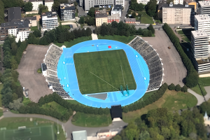 Luftaufnahme des Olympiastadions in München, Deutschland, umgeben von Gebäuden, Bäumen, Straßen, Fahrzeugen und Gras.