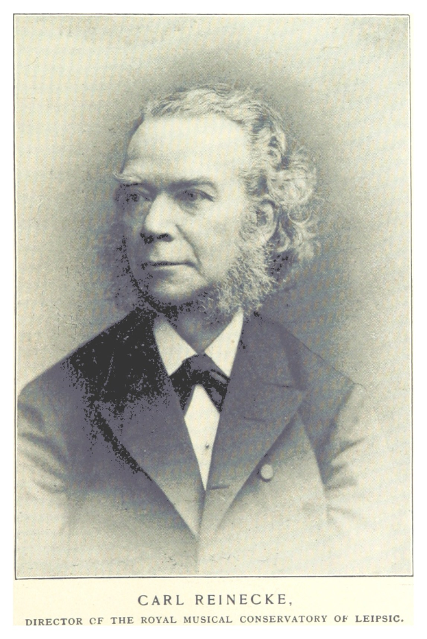 Schwarz-weiß-Porträt von Carl Reinecke, Direktor der Königlichen Musikalischen Hochschule Leipzig, in einem Anzug mit Text unten.